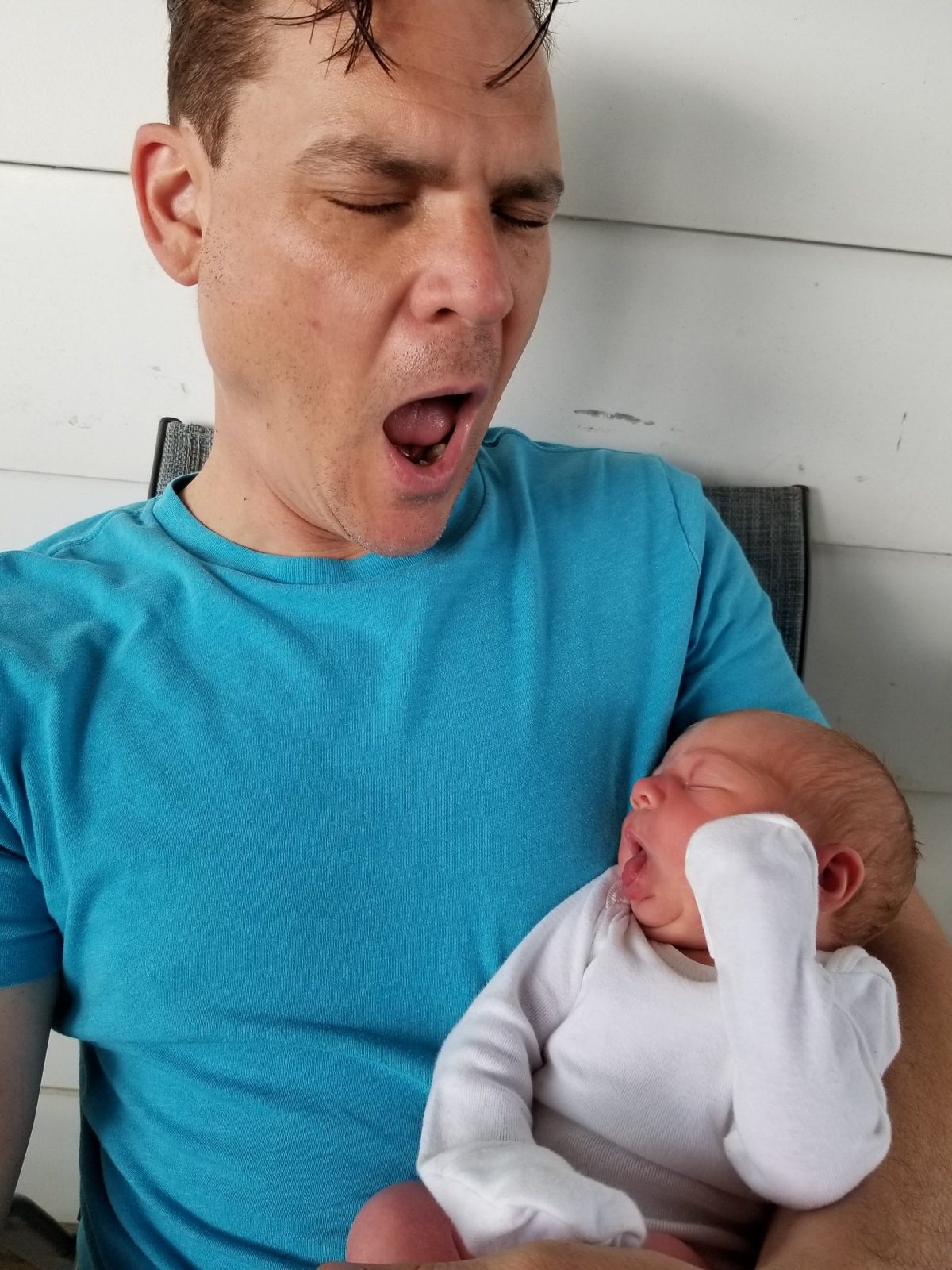 Bam holding his newborn granddaughter